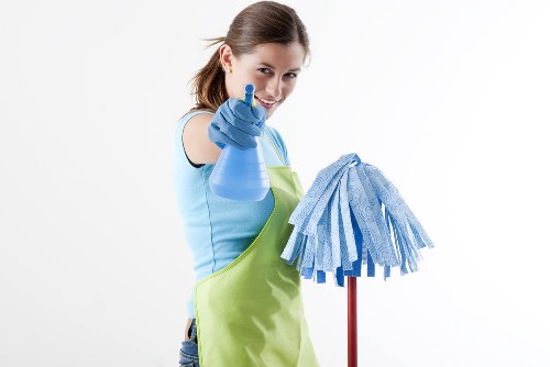 Tenant cleaning a kitchen during end-of-tenancy preparation